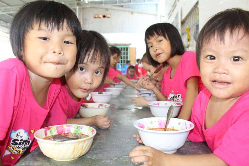 Children sitting around the table eating