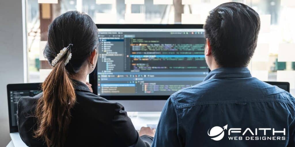 Man and women looking at website code